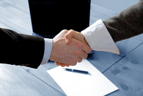 Man and Woman Shaking Hands in a Real Estate Agreement